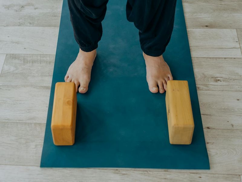 Detailed shot of a professional yoga mat and wooden blocks